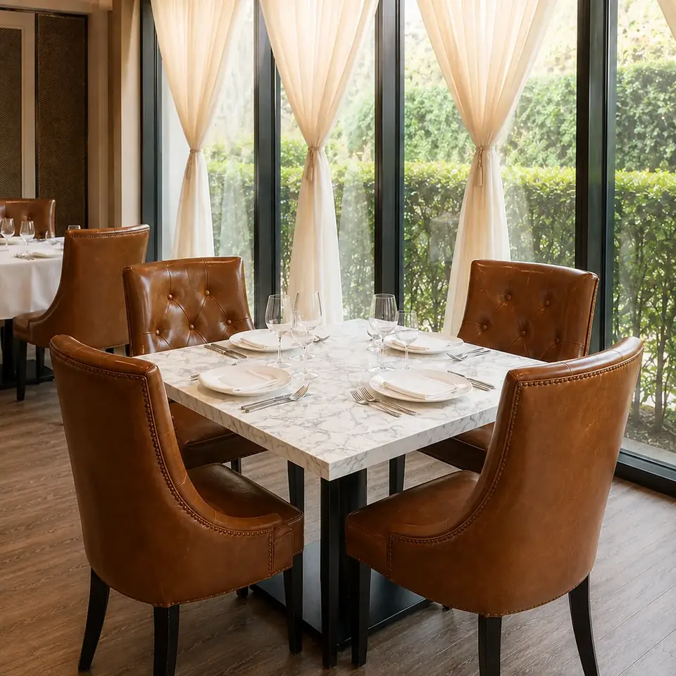 A square marble table for four by the windows at CALI Raffles Place.